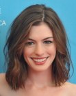Anne Hathaway wearing her medium length hair in a just out of bed style