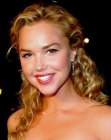 Arielle Kebbel wearing her hair with spiral curls and tucked behind the ears