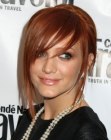 Redhead Ashlee Simpson with the back of her hair wound into an up-style