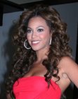 Beyonce Knowles wearing her curly hair in a past the shoulders style