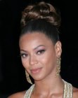 Beyonce Knowles sporting an up style with curls in the crown