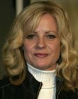 Bonnie Hunt wearing her layered hair long and curled