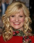 Bonnie Hunt's long blonde hair with loose spiral curls
