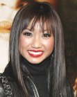 Brenda Song sporting long and sleek black hair with bangs