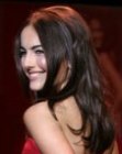 Camilla Belle sporting dark long hair that falls to the middle of her back