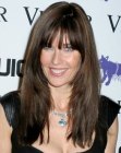 Brunette Carol Alt wearing her hair long and textured with bangs