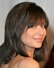 Brunette Catherine Bell sporting a smooth long bob with angled bangs