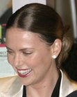 Charlize Theron with her hair brushed back into a chignon