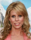 Cheryl Hines with her long blonde hair styled into barrel curls