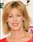 Christine Lahti wearing her hair in a halfway the neck cut with layers