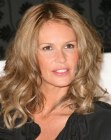 Elle MacPherson's just below the shoulders hair with curls