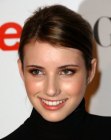 Emma Roberts wearing her long brown hair in a sleek ponytail