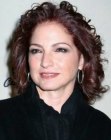 Gloria Estefan's curly shoulder length hair with highlights