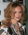 Heather Graham sporting a long layered haircut with curled ends