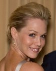 Jennie Garth with her hair styled up and back into a chignon