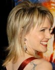 Kathryn Morris wearing her mid length hair in a classic razor cut shag