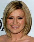 Kelly Clarkson with her straight hair cut into a below the chin bob