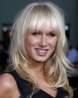 Kimberley Stewart's long blonde hairstyle with chopped bangs
