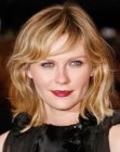 Kirsten Dunst with her hair cut into a versatile almost shoulder length shag