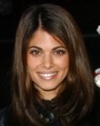 Lindsay Hartley with the ends of her long hair styled to curl toward one another