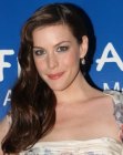Liv Tyler wearing her brown hair with layers and waves