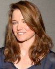 Lucy Lawless with her hair cut in a long casual style with layers