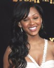 Megan Good sporting a very long hairstyle with curls