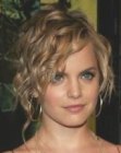 Mena Suvari with her hair in a partial up style with curls