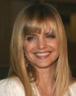 Mena Suvari wearing her blonde hair long with tapered sides and bangs