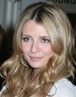 Mischa Barton sporting a long hairstyle with curls and a middle part