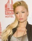 Paris Hilton wearing her long ponytail over one shoulder