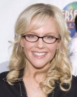 Rachael Harris with her hair curled away from the face