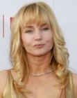 Rebecca De Mornay wearing her hair long with bangs and curled ends