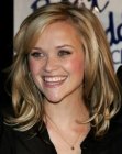 Reese Witherspoon with her hair cut in a layered shoulder length style