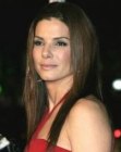 Sandra Bullock's sleek long hairstyle with layering and a middle part
