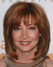 Sharon Lawrence's medium length hairstyle with layers and jagged bangs 