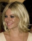 Sienna Miller's medium length hairstyle with layers and bangs