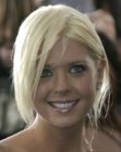 Tara Reid with her blonde hair partly pulled back in a ponytail