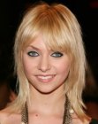 Taylor Momsen sporting a medium length layered hairstyle with bangs