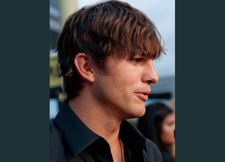 Ashton Kutcher with hair that falls below his eyebrows