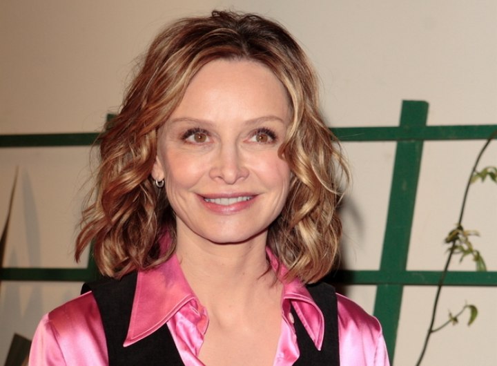 Calista Flockhart with coiled hair and wearing a satin blouse