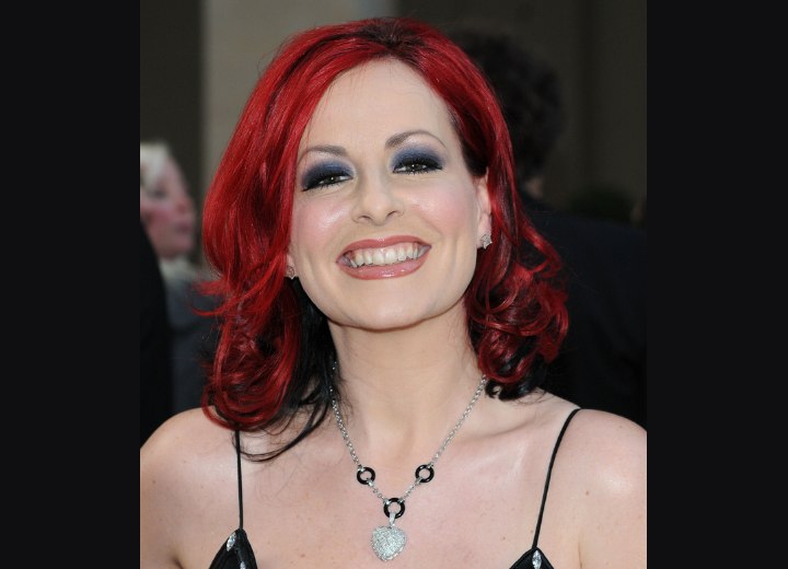 Carrie Grant's lava red hair cut to touch the shoulders
