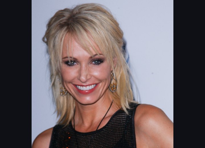 Josie Bissett wearing her hair with long split bangs