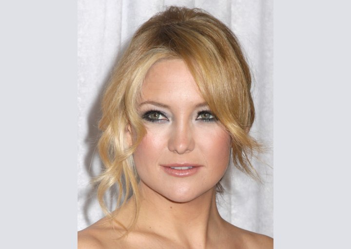 Kate Hudson with her hair gathered in a braid