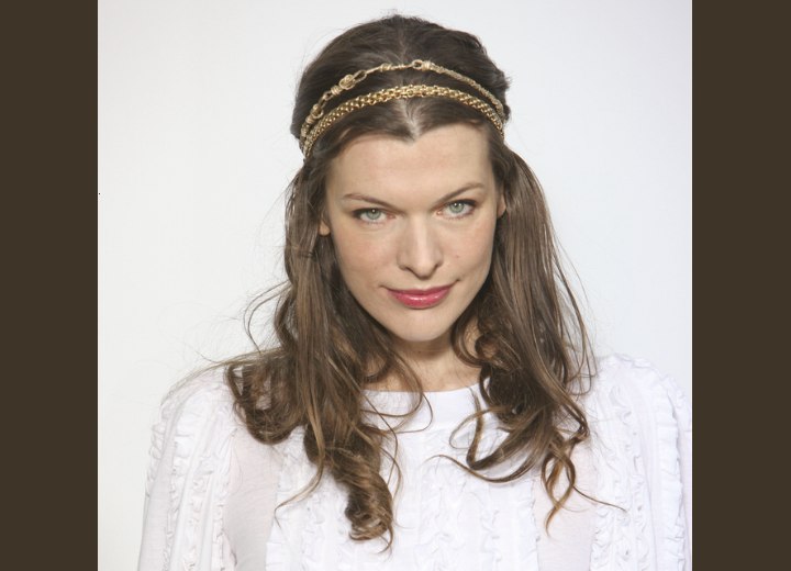 Milla Jovovich wearing her hair with shoulder long curls