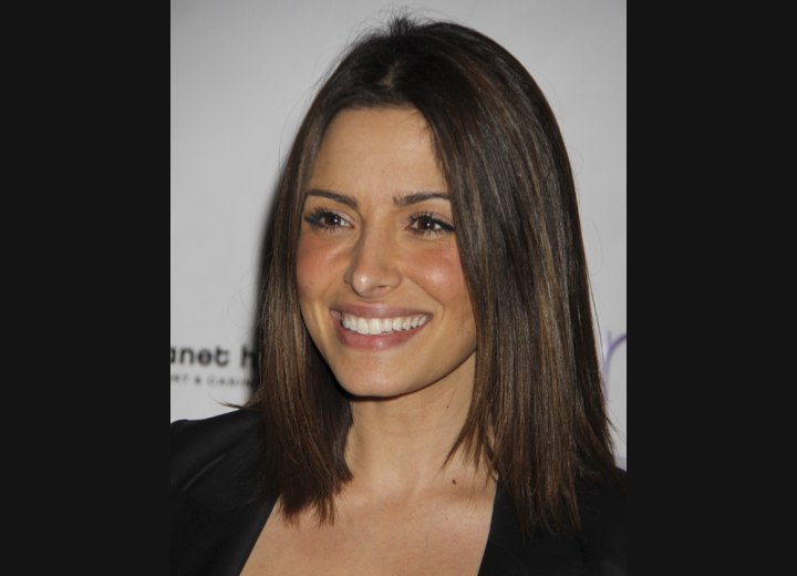 Sarah Shahi with straight hair that touches the shoulders