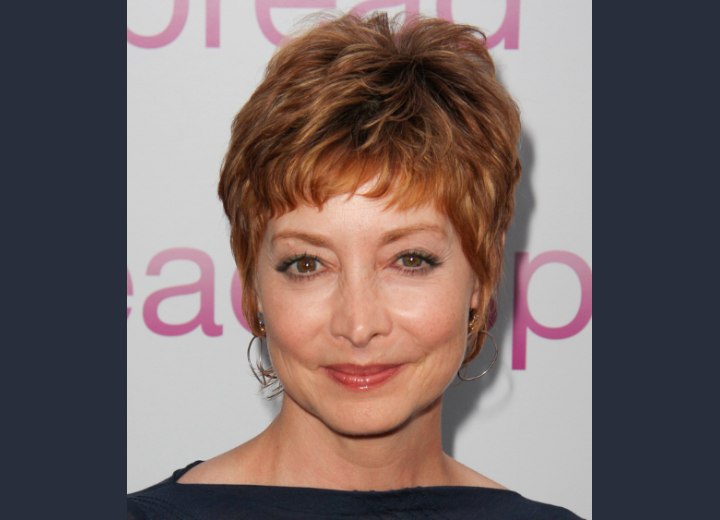Sharon Lawrence wearing a pixie cut with short bangs