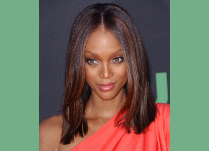 Tyra Banks wearing her long straight hair in a blunt cut