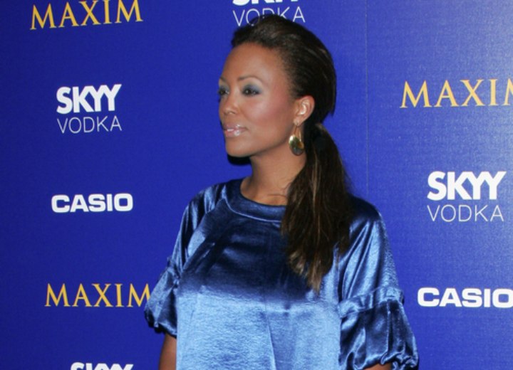 Aisha Tyler wearing a shimmery blue dress