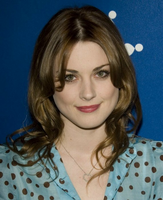Alexandra Breckenridge wearing her long hair parted in the 